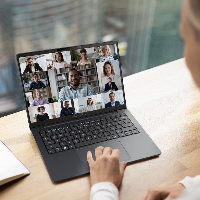 A female working professional engaging in conference call using ASUS ExpertBook B3. 